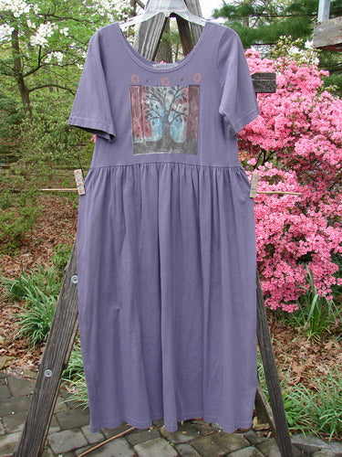 1996 Short Sleeved Simple Dress Tree of Life Purple Martin Size 0 hanging on a clothesline, showcasing its slightly deeper rounded neckline, drop empire waist seam, and Tree of Life theme paint.