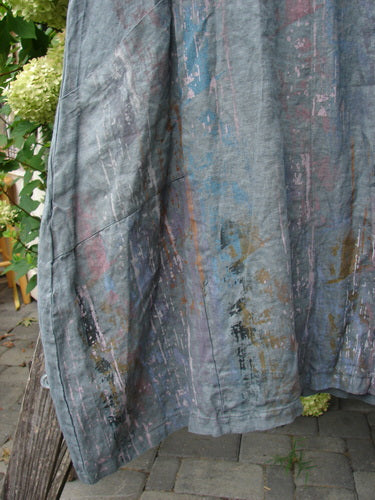 Barclay NWT Linen Cross Over Urchin Pocket Dress Vertical Rain Smudge Stick Size 0 displayed outdoors, showcasing its watercolor-like design with pastel hues and unique pocket features against a natural backdrop.