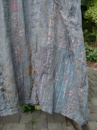 Barclay NWT Linen Cross Over Urchin Pocket Dress Vertical Rain Smudge Stick Size 0, displayed on a weathered drop cloth, features a unique paint-splattered design, emphasizing its artistic and vintage-inspired aesthetic.