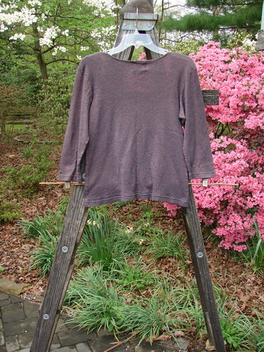 2000 Litmus Squareneck Top Unpainted Iron Size 1 displayed on a wooden stand, showcasing its wide, rounded neckline and slightly flared hip. A vintage, elegant piece with neat stitching accents.