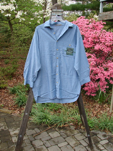 1998 Men's Lightweight Brushed Cotton Long Sleeved Oxford Shirt Earth Indigo Size XL displayed on a wooden hanger, featuring a front painted breast pocket and longer cuffed sleeves with button closures.