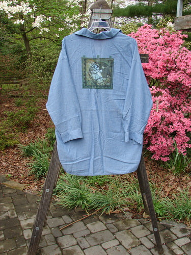 1998 Men's Lightweight Brushed Cotton Long Sleeved Oxford Shirt Earth Indigo Size XL displayed on a wooden stand, featuring a front painted breast pocket, long cuffed sleeves, and varied hemlines.