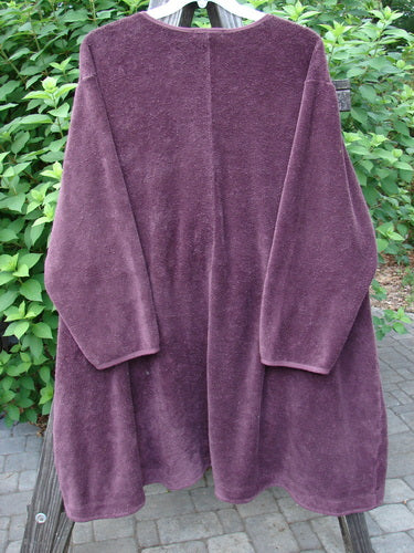 Barclay Chenille Rippie Tie Front Robe Jacket Unpainted Murple Size 2: A medium-weight purple robe with a tie front and double drop front exterior pockets. It features an A-line shape, varying hemline, deep V-shaped neckline, and double-stitched sleeve finishes.