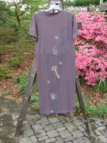 1996 Long Tee Dress Lolly Flower Violet Field Altered Size 0 displayed on a wooden stand, showcasing its rounded paneled neckline, short wide sleeves, and seamless front and back.