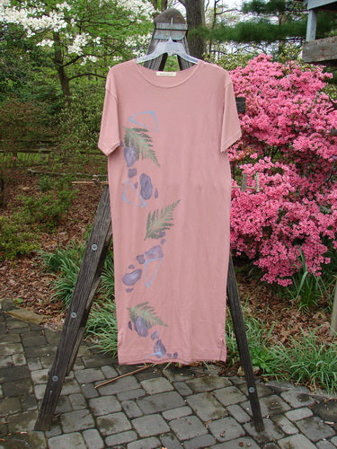 1996 Long Tee Dress Fern Stone Petal Altered Size 0 displayed on a wooden post, showcasing its seamless front, short wide sleeves, rounded paneled neckline, and vented hemline.