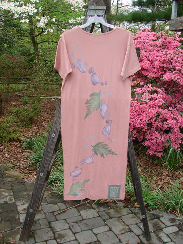 1996 Long Tee Dress Fern Stone Petal Altered Size 0 displayed on a wooden stand, featuring a rounded paneled neckline, short wide sleeves, and a seamless front and back with blue prints.