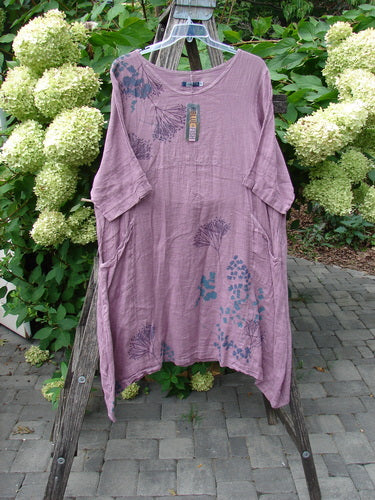 Barclay NWT Linen Wave Pocket Dress in Tulsi Rose, displayed on a wooden ladder. Features include a loose fit, rounded neckline, seamless bodice, and floral print. Size 0.