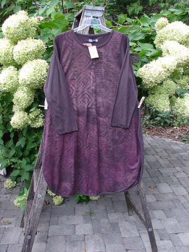 Barclay NWT Natalia Tunic Grid Pod Red Peat Size 0 on hanger over wooden ladder, showcasing loose-cut design with round neckline, rounded hem, long sleeves with lettuce edges, and high side vents.