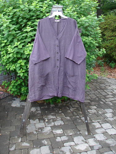 Barclay Linen Cotton Sleeve Pocket Cardigan Unpainted Dusty Plum Size 2: A purple shirt on a swinger with wooden buttons and drop front squared off pockets.