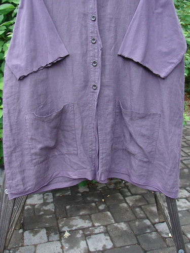 Image: A purple cardigan with wooden buttons, drop shoulders, and squared off pockets.

Context: Barclay Linen Cotton Sleeve Pocket Cardigan Unpainted Dusty Plum Size 2

Alt text: Barclay Linen Cotton Sleeve Pocket Cardigan in Dusty Plum with wooden buttons and squared off pockets.