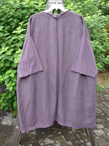 Barclay Linen Cotton Sleeve Pocket Cardigan Unpainted Dusty Plum Size 2: A purple cardigan with wooden buttons, drop shoulders, and squared off pockets.