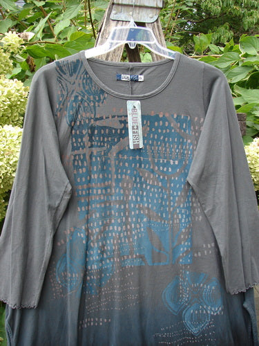 Barclay NWT Natalia Tunic Rain Pod Twilight Grey Size 0 features a round neckline, long sleeves with lettuce edges, abstract dot and floral patterns, and high side vents, hung against a garden backdrop.