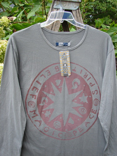 Barclay NWT Long Sleeved Studio Tee Belief Spirit Magic Grey Moonlight Size 0, features a circular graphic with “SPIRIT,” “PEACE,” “LOVE,” and “MAGIC” on front, highlighted by cozy long sleeves.