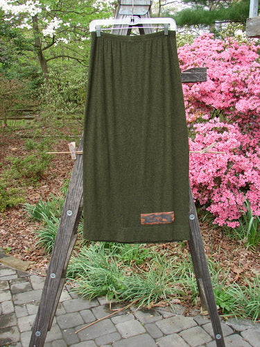 2000 Patched Rayon Lycra Rib Linear Skirt Green Oak Heather Size 0 displayed on a wooden ladder, highlighting its full elastic waistband and slightly flared lower shape with exterior horizontal hem stitching.