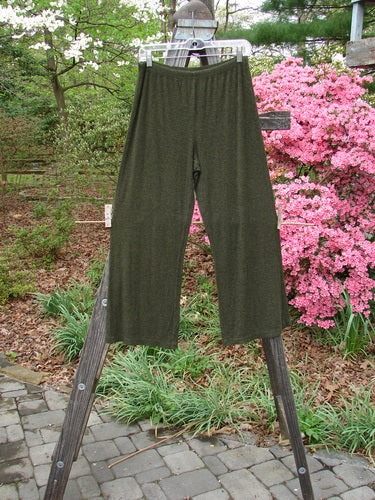 2000 Rayon Lycra Rib Flare Pant Unpainted Green Oak Heather Size 1 displayed on a wooden rack outdoors, showcasing its full elastic waistline, slightly flared bottom, and superior drape.