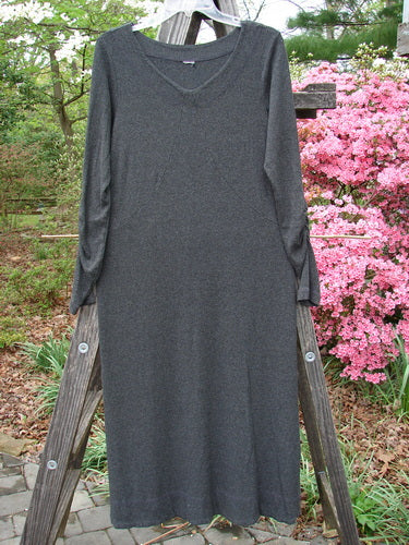 Long black 2000 Rayon Lycra Rib Julia Dress hanging on wooden rack, featuring sectional front crisscross, gathered forearms, and soft rounded neckline.