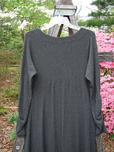 Grey Julia Dress from the Holiday 2000 Collection in Charcoal Heather on a clothes rack, highlighting its sectional front crisscross, gathered forearms, and soft rounded neckline.