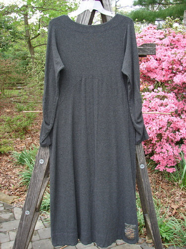 2000 Rayon Lycra Rib Julia Dress Green Unpainted Charcoal Heather Size 0 displayed draped on a wooden ladder. The dress features a sectional front crisscross, gathered forearms, and a soft rounded neckline.