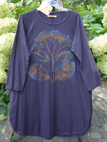 Barclay NWT Natalia Tunic Dried Floral Metallics Plum River Size 1, featuring a stylized botanical print in muted gold and teal, with lettuce-edged sleeves and high side vents, hanging outdoors.