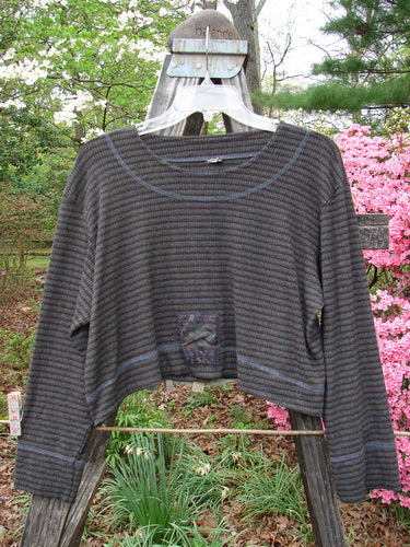 2000 Patched Rayon Lycra Rib Overtop Burgundy Stripe Size 1 displayed on a mannequin swing outdoors, highlighting its unique upward scooping hemline, exterior stitchery, and Celtic-themed painted patches.