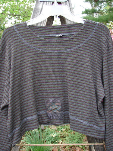 2000 Patched Rayon Lycra Rib Overtop Burgundy Stripe Size 1 displayed on a hanger, showcasing its varying hemline, exterior stitchery, and painted Celtic theme patches.