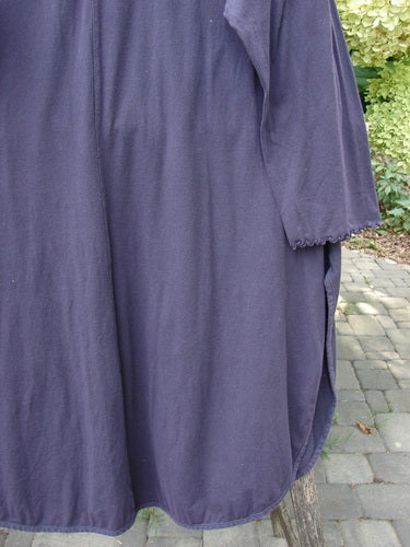 Barclay NWT Natalia Tunic Dried Floral Metallics Plum River Size 1, featuring a loose fit, rounded neckline, long sleeves with lettuce edges, and high side vents, displayed outdoors.