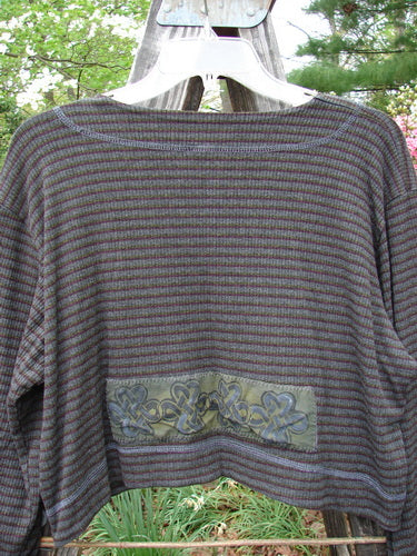 2000 Patched Rayon Lycra Rib Overtop Burgundy Stripe Size 1 displayed on a hanger, highlighting its textured, softly flowing fabric and unique Celtic-themed painted patches.