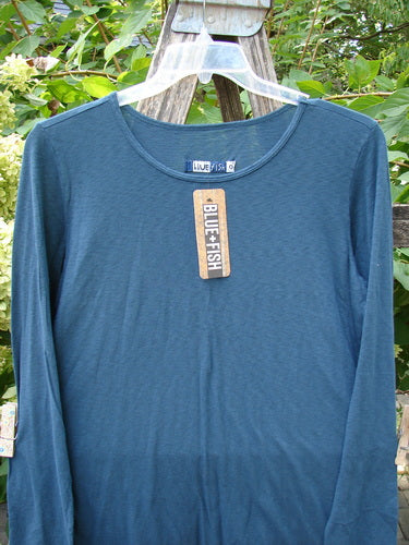 Barclay NWT Modal Slub Long Sleeved Simple Tee Unpainted Morocco Size 0 displayed over a wooden ladder, highlighting its long sleeves, A-line shape, raw edges, and rounded neckline.