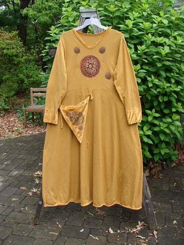 1996 Velvet Ornamental Pocket Dress, Celtic Center Gold Size 2, featuring velvet accents on the neck, hem, and sleeves, with a dramatic painted hand purse and sweeping A-line shape with spirograph patterns.
