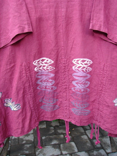 Barclay Linen Venetian High Vent Tunic Dress Cornflower Berry Size 2: A flowing pink shirt with white designs, featuring an hourglass shape, wider hip and hemline, and S-shaped seams.
