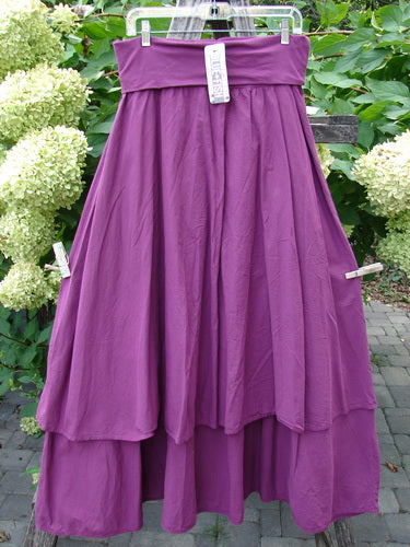 Barclay NWT Batiste Fold Over Stardust Tier Skirt Tyrian Berry Size 0, featuring a flowy, ankle-length design with two layered tiers and a forgiving waistline, displayed outdoors on a hanger.