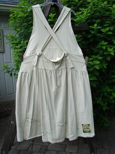 Image alt text: "1999 NWT Tadpole Jumper Double Dot Fish Natural OSFA, a white dress on a clothesline, featuring fully adjustable shoulder straps, a huge sweeping hemline, a drawcord criss-cross lower back, and a downward yoked and slight empire double paneled waistline."