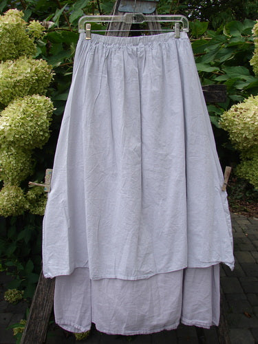 Barclay NWT Batiste Two Story Shaunting Skirt in Pearl Smoke, displayed outdoors, showcases a lightweight, double-layered design with a full elastic waist, perfect for complementing Blue Fish styles.