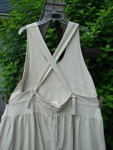 A white dress on a swinger, featuring fully adjustable shoulder straps, a huge sweeping hemline, and a criss-cross lower back. This New With Tag Tadpole Jumper is from the Summer Collection of 2000 in Natural, made from Organic Cotton. Bust 40 and Open, Waist 50, Hips 60, Length 46-52 inches.