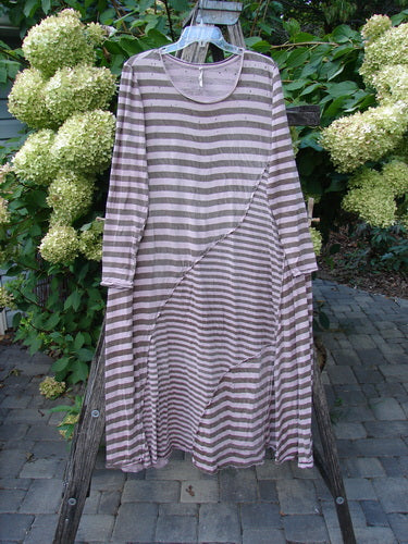 Magnolia Pearl Cotton Dylan Dress Hand Mended Lavender Stripe OSFA, features long sleeves, ankle length, and horizontal stripes, draped over a rustic ladder with a garden backdrop, embodying BlueFishFinder's vintage aesthetic.