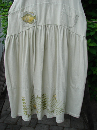 Image alt text: "1999 NWT Tadpole Jumper with fish design on white skirt, fully adjustable shoulder straps, criss-cross lower back, and round bottomed pockets"