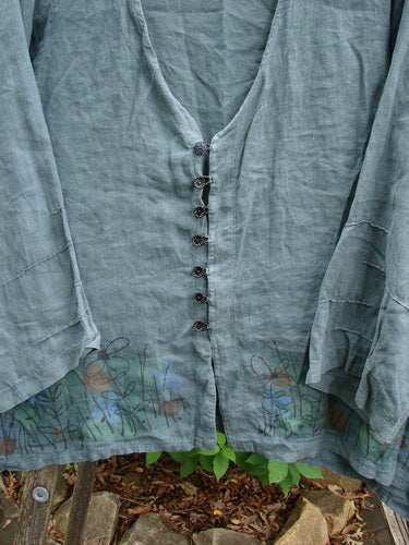 Barclay Linen Tiny Button Dip Side Cardigan Daisy Field Green Mineral Size 0 featuring a deep V-neckline, vented hemline, and textured shiny buttons, ideal for expressing individuality through vintage-inspired summer style.