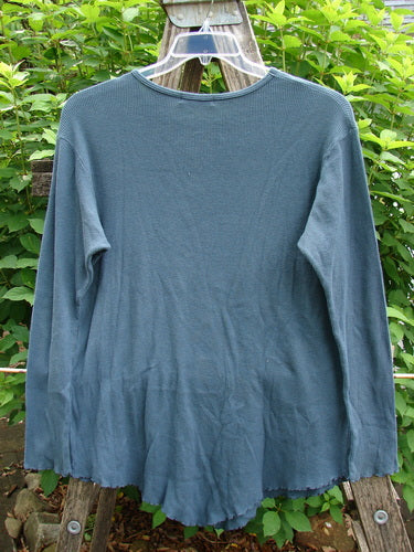 Barclay Thermal Stretch Long Sleeved Curl Edge Top features a rounded rolled neckline, longer sleeves with curly edges, and a reverse hemline, embodying BlueFishFinder's vintage creativity.