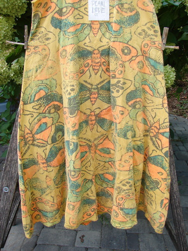 Magnolia Pearl NWT Cotton Fleece Lepidoptera Lana Tank Dress Butterfly Sunnies OSFA displayed on a wooden frame, featuring kaleidoscopic butterfly patterns and raw edges, embodying BlueFishFinder's creative and vintage style.