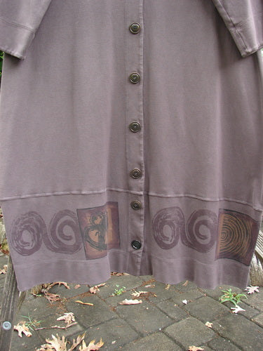 2000 Interlock Glassgow Coat Dress features oversized buttons, a painted bottom panel, and a continuous Celtic theme. With a V-shaped neckline and swingy hem, it embodies vintage Blue Fish creativity.