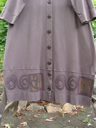 2000 Interlock Glassgow Coat Dress features oversized buttons, a painted bottom panel, V-shaped neckline, wide hem, and Celtic theme. Size 0 with generous swing, perfect for expressing individuality.
