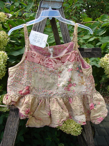 Magnolia Pearl NWT Quilted Catalina Tank Ragdoll Calico OSFA features a patchwork style with a ruffled hem and hand-mending details, displayed elegantly on a hanger with a tag, emphasizing its unique shabby-chic design.