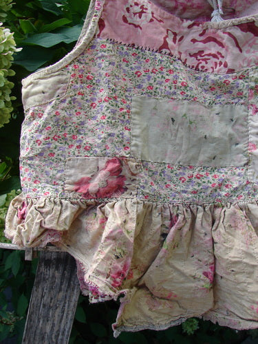 Magnolia Pearl NWT Quilted Catalina Tank Ragdoll Calico OSFA, featuring a vintage patchwork design with ruffled hem and distressed accents, hangs outdoors, showcasing embroidery and quilting on European cotton.