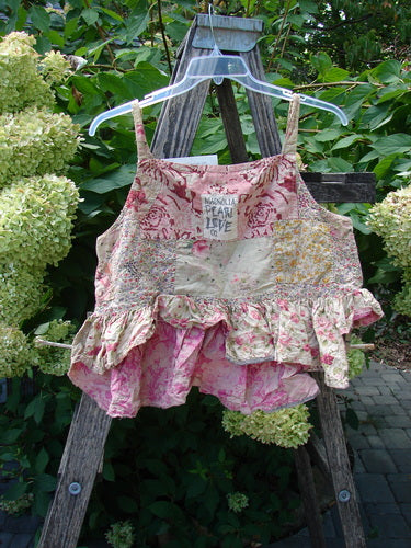 Magnolia Pearl NWT Quilted Catalina Tank Ragdoll Calico OSFA displayed on a wooden ladder, showcasing patchwork floral prints, ruffled hem, and HEART LOVE label, embodying creative individuality from Bluefishfinder.com.