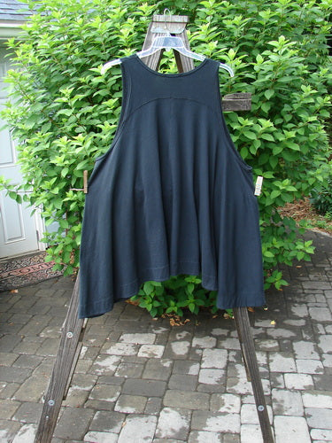 Image alt text: Barclay Column Vest in Midnight, Size 2, on wooden rack. Swingy shape, dark buttons, varying hemline, deep pockets. Organic cotton.