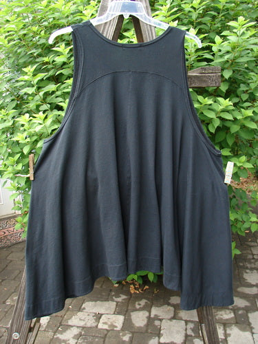 A black Barclay Column Vest in midnight, size 2, made from organic cotton. Features include a swingy shape, not too deep arm openings, a downward yoked upper back shoulder panel, a varying and banded swaying hemline, and a row of dark contrasting buttons. Side seam deep pockets and a super varying hemline ensure the best fit. Bust: 19 and open, waist: 54, hips: 60, hem circumference: 100, front length: 33, side lengths: 38 inches.
