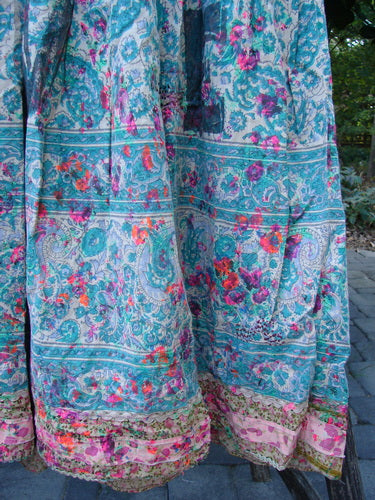 Magnolia Pearl NWT European Cotton Block Print Taigi Dress Demi OSFA showcases a flowing skirt with intricate paisley borders, vibrant floral motifs, and delicate pintucks, embodying artistic individuality from Bluefishfinder.com.