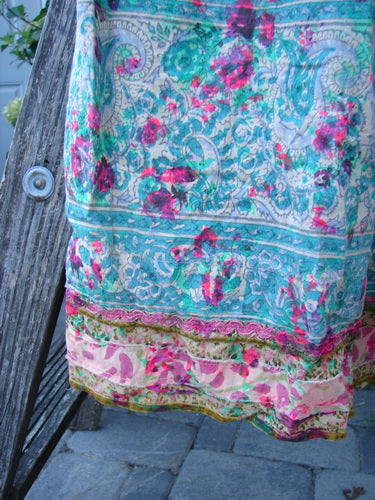 Magnolia Pearl NWT European Cotton Block Print Taigi Dress Demi OSFA displayed with floral-paisley motifs and contrasting hem, draped over weathered wood, highlighting its bohemian style and detailed craftsmanship.