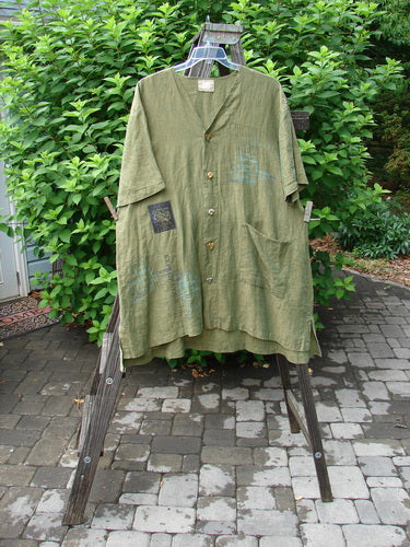 2000 Cross Dye Linen Patched Downtown Jacket in Meadow, Size 2. A green shirt with patches on a clothes rack.