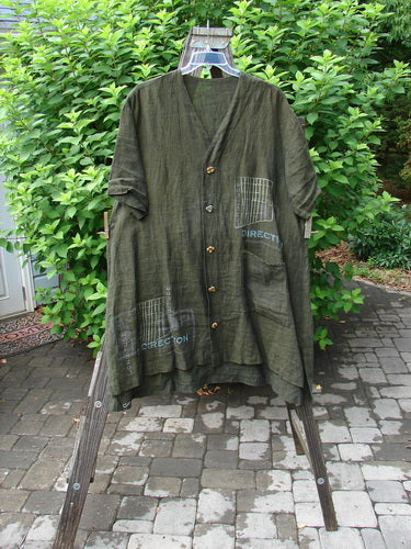 2000 Cross Dye Linen Downtown Jacket Directional Oregano Size 2: A green shirt on a swinger with ceramic glazed buttons and a V-shaped neckline.